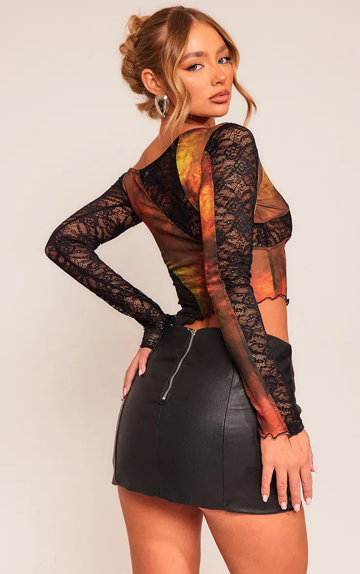 Top asymétrique en mesh imprimé noir à parties en dentelle